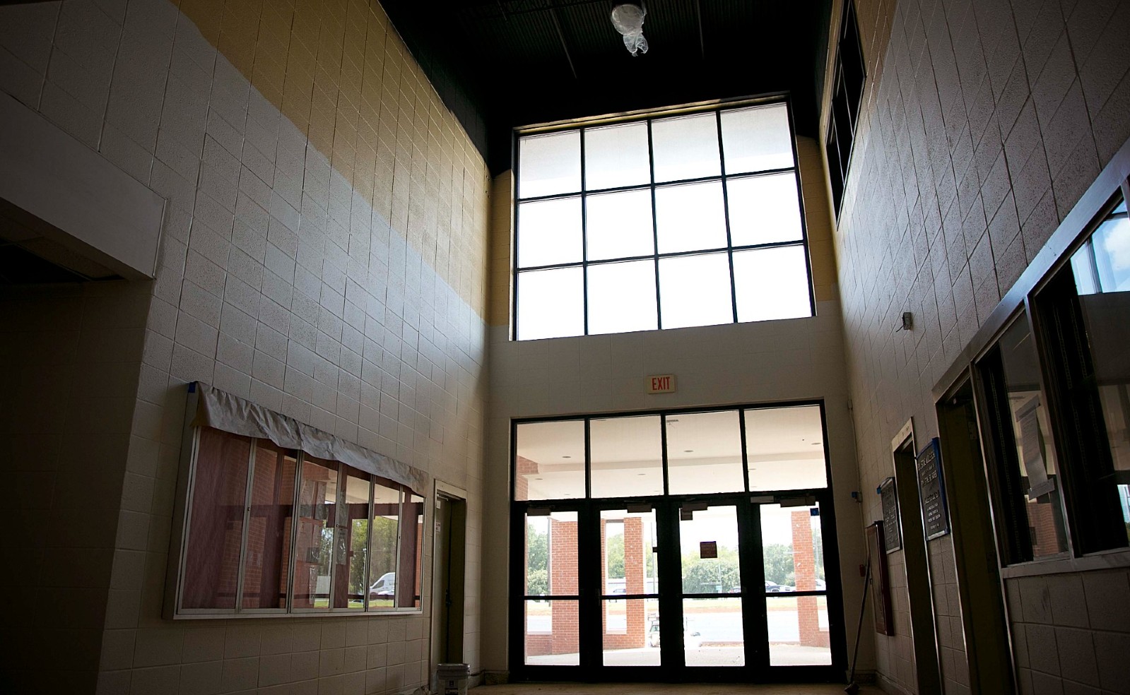 Former school hallway with red lockers during renovation